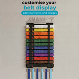 Belt display with colorful martial arts belts and medals with the option to personalise the hanger on a gray background