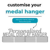 A personalized metal medal display hanger. Large text above reads 'Personalised MEDAL DISPLAY HANGER' with smaller text 'customise your medal hanger' and 'add your name, sport or favourite quote'.