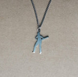 A silver-colored stainless steel pendant depicting a cricket player in mid-swing, attached to a chain.