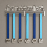 Medal holder with motivational quote and medals on a gray background - Christian quote saying I can do all things through Christ who strengthens me