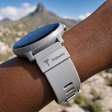 Smartwatch with a diabetic medical alert band on a person's wrist, set against a mountainous landscape.