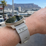 Smartwatch with 'Medical Info' band on wrist, blurred cityscape in background. Personalised Watch Tag SA Medal Hangers