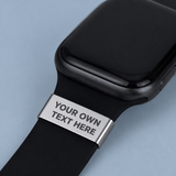 Black smartwatch with a customizable metal band on a light blue background