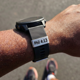 Person wearing a smartwatch with a 'Phil 4:13' watch tag SA Medal Hangers