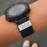 Smartwatch on a wrist with motivational message display, saying when your legs get tired run with your heart on the watch tag