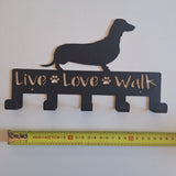 25cm Black metal lead hanger with 5 hooks and a dachshund silhouette and 'Live Love Walk' text, next to a ruler for scale.